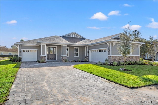 view of front of home featuring a garage and a front lawn