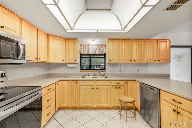 262 N Indianapolis Ave, Hernando, FL 34442 - kitchen featuring appliances with stainless steel finishes, light brown cabinets, a sink, light countertops, and light tile patterned floors