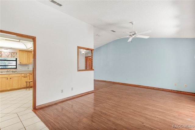 262 N Indianapolis Ave, Hernando, FL 34442 - spare room featuring ceiling fan, lofted ceiling, a sink, light wood-style floors, and baseboards