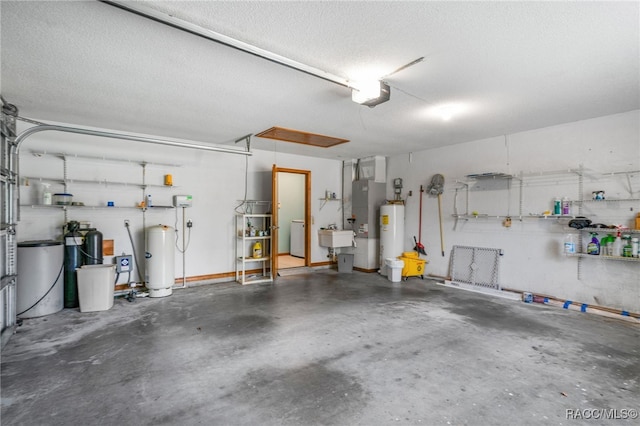 262 N Indianapolis Ave, Hernando, FL 34442 - garage with electric water heater, a garage door opener, a sink, and washer / dryer