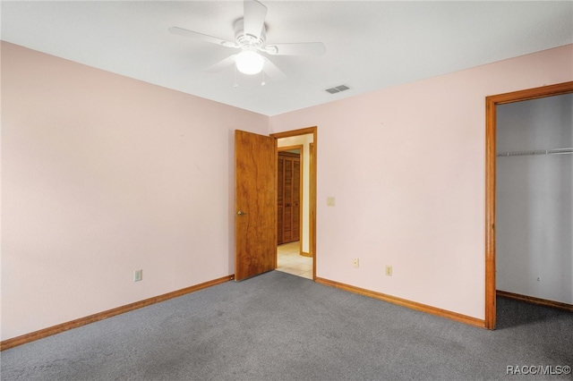 262 N Indianapolis Ave, Hernando, FL 34442 - unfurnished bedroom featuring carpet floors, a closet, baseboards, a spacious closet, and ceiling fan