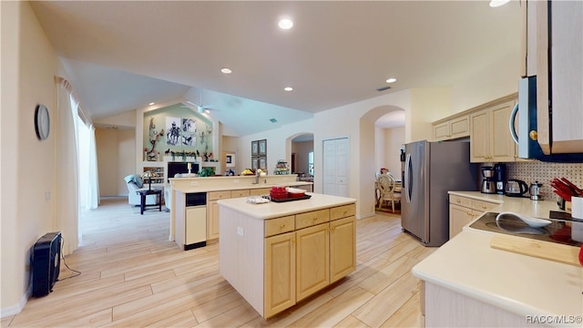 4690 W Tomahawk Dr, Beverly Hills, FL 34465 - kitchen featuring arched walkways, a center island, light countertops, open floor plan, and appliances with stainless steel finishes