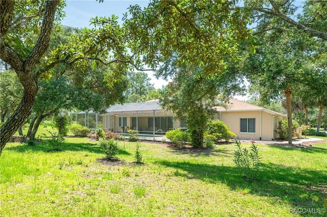 4690 W Tomahawk Dr, Beverly Hills, FL 34465 - back of property featuring a lawn and a lanai