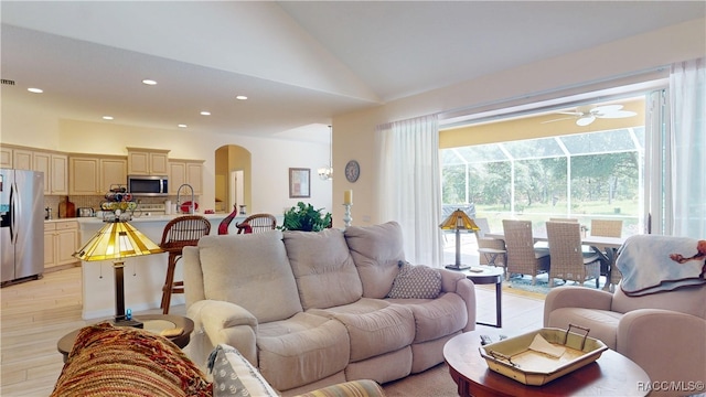 4690 W Tomahawk Dr, Beverly Hills, FL 34465 - living area featuring arched walkways, ceiling fan, light wood finished floors, vaulted ceiling, and recessed lighting