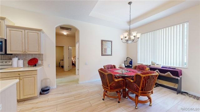 4690 W Tomahawk Dr, Beverly Hills, FL 34465 - dining room featuring arched walkways, light wood-style flooring, a chandelier, and baseboards