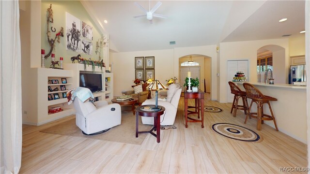 4690 W Tomahawk Dr, Beverly Hills, FL 34465 - living area featuring arched walkways, light wood finished floors, high vaulted ceiling, and recessed lighting