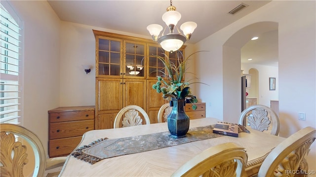 4690 W Tomahawk Dr, Beverly Hills, FL 34465 - dining space with arched walkways, a chandelier, and recessed lighting