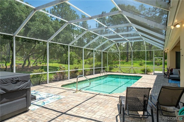 4690 W Tomahawk Dr, Beverly Hills, FL 34465 - outdoor pool featuring a patio, glass enclosure, and view of scattered trees