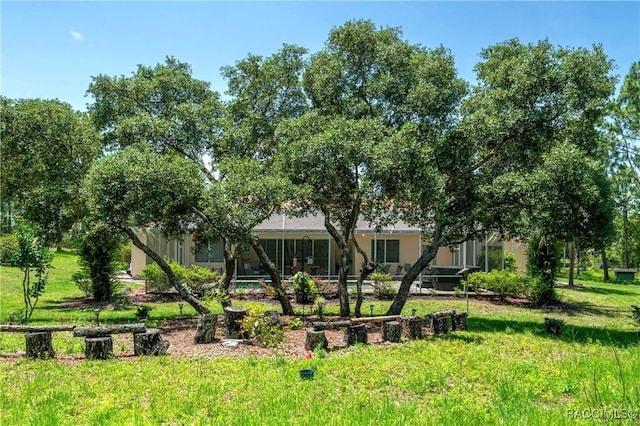 4690 W Tomahawk Dr, Beverly Hills, FL 34465 - rear view of property with a yard and a swimming pool