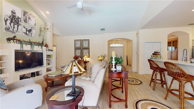 4690 W Tomahawk Dr, Beverly Hills, FL 34465 - living area featuring arched walkways, ceiling fan, light wood-style flooring, and lofted ceiling