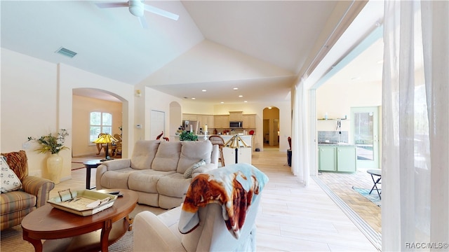 4690 W Tomahawk Dr, Beverly Hills, FL 34465 - living room with arched walkways, ceiling fan, light wood finished floors, and high vaulted ceiling