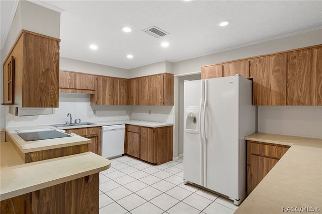 kitchen with sink, a textured ceiling, white appliances, light tile patterned floors, and ornamental molding