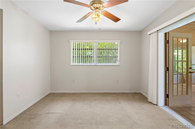 unfurnished room featuring light carpet and ceiling fan