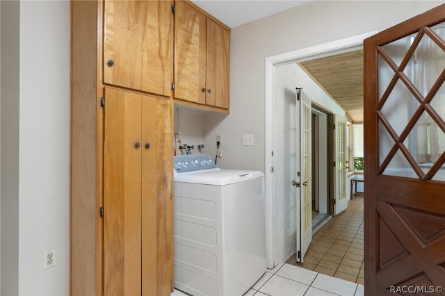 laundry area featuring cabinets, light tile patterned floors, washer / clothes dryer, and wood ceiling