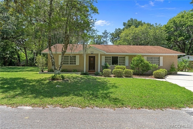 ranch-style home featuring a front yard