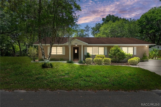 ranch-style house featuring a lawn