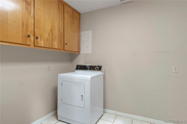 washroom featuring washer / clothes dryer, light tile patterned floors, and cabinets