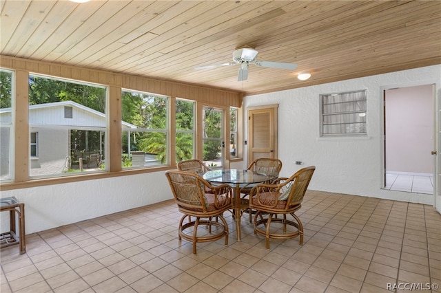 tiled dining space featuring ceiling fan and wooden ceiling