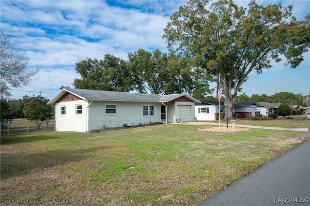 single story home featuring an attached garage, driveway, fence, and a front lawn