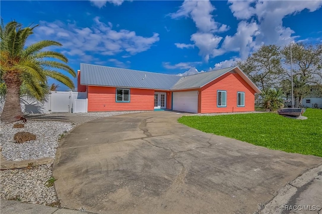 view of front facade with a garage and a front lawn