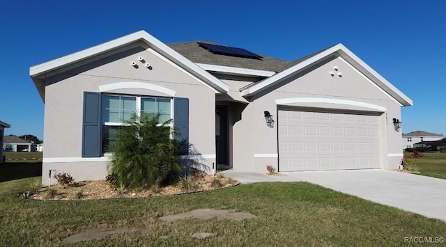 single story home featuring solar panels, a garage, and a front lawn