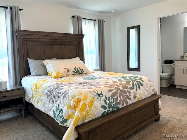 carpeted bedroom with ensuite bathroom