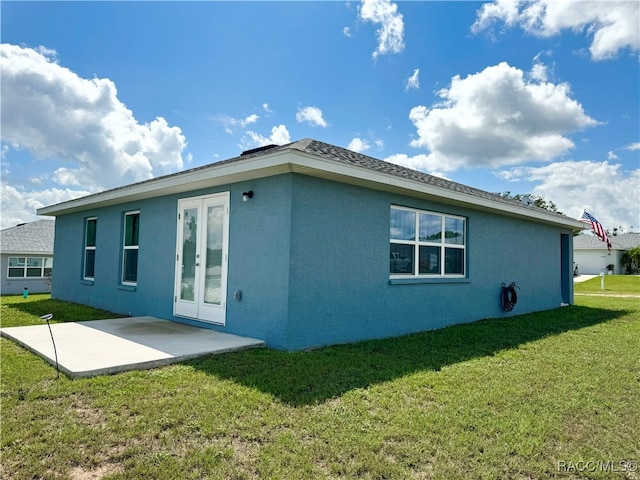 back of property featuring a lawn and a patio area