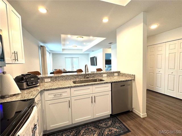 kitchen featuring dishwasher, dark hardwood / wood-style floors, white cabinetry, and sink