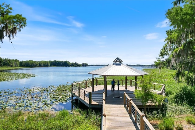 view of dock featuring a gazebo and a water view