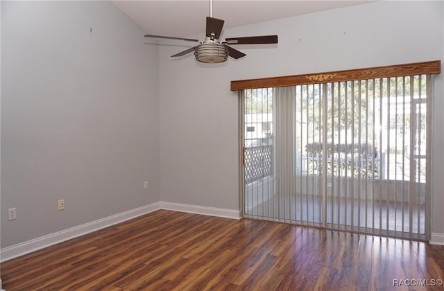 empty room with ceiling fan, dark hardwood / wood-style flooring, and lofted ceiling