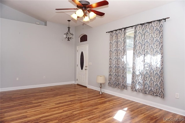 foyer with ceiling fan with notable chandelier and hardwood / wood-style flooring