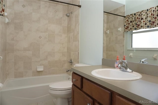 full bathroom with vanity, toilet, and tiled shower / bath