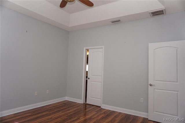 spare room featuring dark hardwood / wood-style floors and ceiling fan