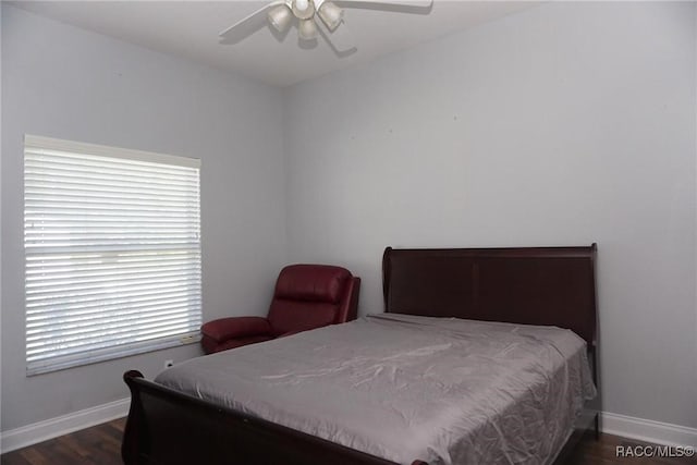 bedroom with ceiling fan and dark hardwood / wood-style flooring