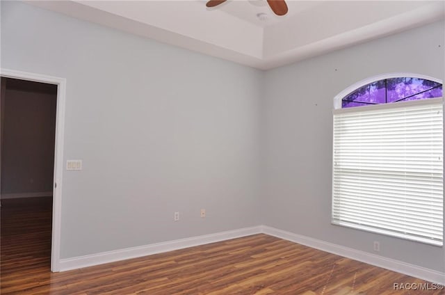 unfurnished room with ceiling fan and dark hardwood / wood-style floors