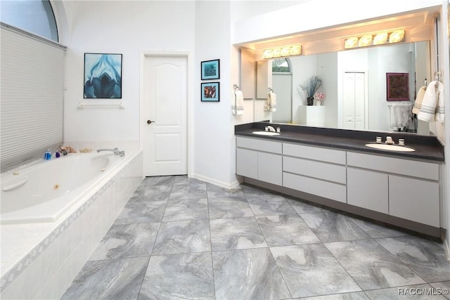 270 E Keller Ct, Hernando, FL 34442 - bathroom with double vanity, a tub with jets, and marble look tile flooring