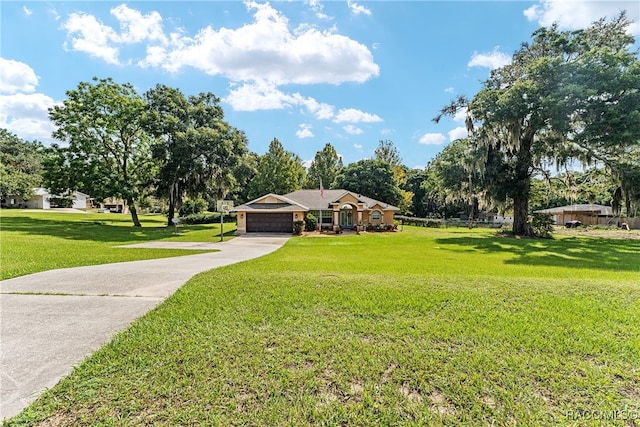 single story home featuring a garage and a front yard