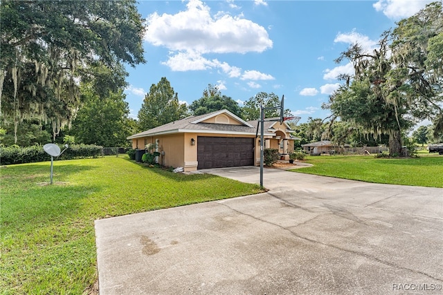 view of side of property featuring a garage and a yard