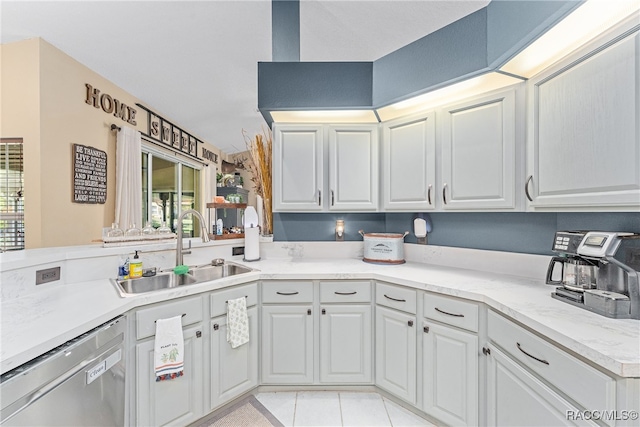 kitchen with white cabinetry, dishwasher, sink, and light tile patterned floors