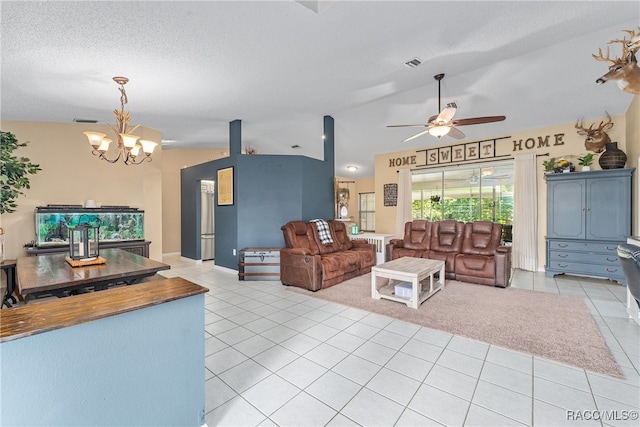 living room featuring ceiling fan with notable chandelier, light tile patterned flooring, a textured ceiling, and vaulted ceiling