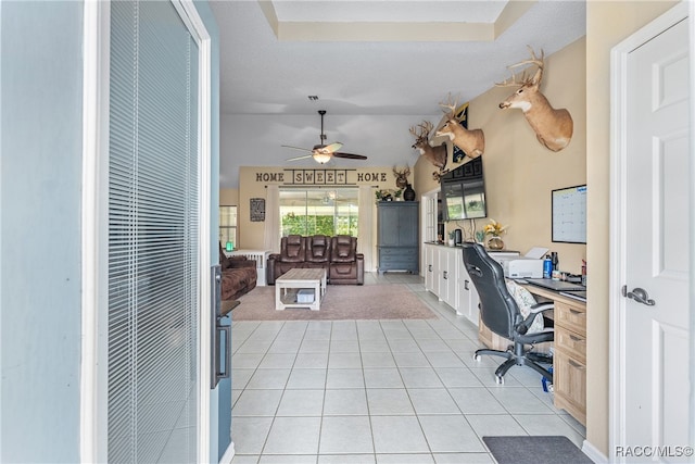 tiled office featuring ceiling fan and a textured ceiling