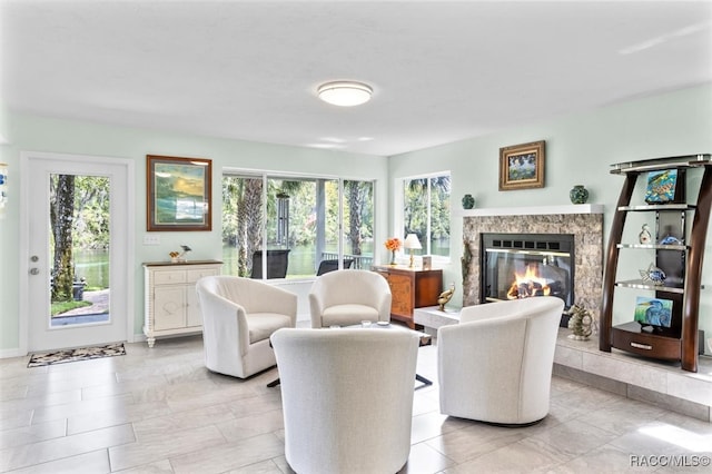 living room featuring a high end fireplace