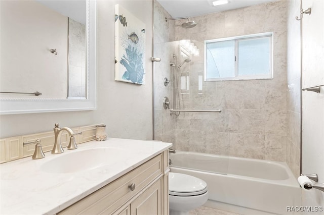 full bathroom with vanity, tiled shower / bath combo, and toilet