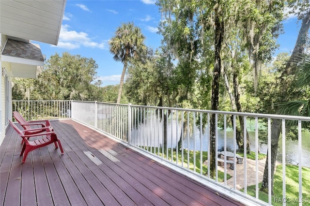 wooden terrace featuring a water view