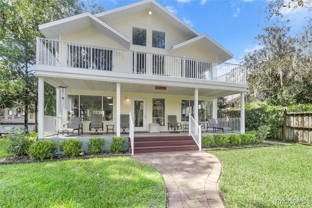 view of front of house with a porch and a front yard