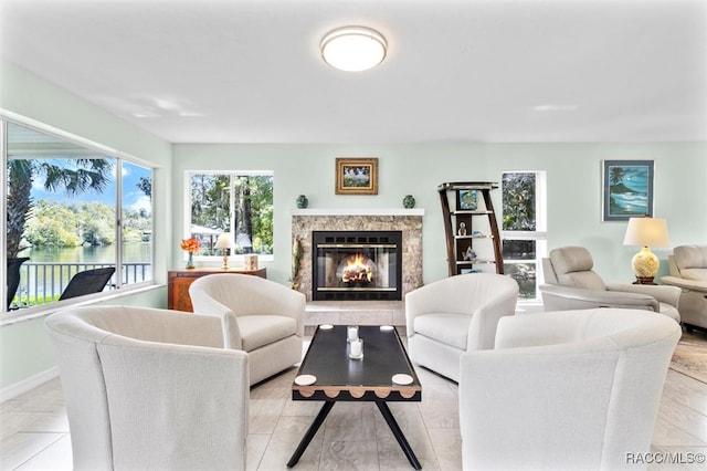 living room with a water view and a premium fireplace