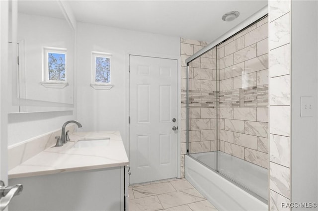 bathroom featuring vanity and shower / bath combination with glass door