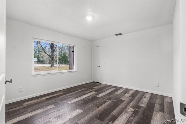 unfurnished room with dark hardwood / wood-style floors