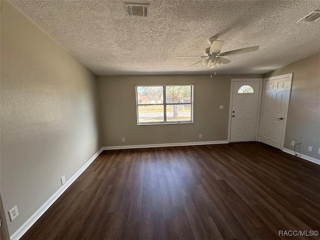 foyer with dark wood-type flooring, ceiling fan, and a textured ceiling