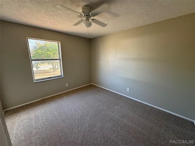 carpeted spare room featuring ceiling fan and a textured ceiling